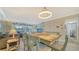 Condo dining area with light wood table and beachy decor at 4380 Exeter Dr # 303, Longboat Key, FL 34228