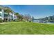 Waterfront condos with lush green lawn and tropical landscaping with boat docks and canal views at 4380 Exeter Dr # 303, Longboat Key, FL 34228