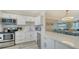 Well-equipped kitchen with white cabinets, stainless steel appliances, and quartz countertops at 4380 Exeter Dr # 303, Longboat Key, FL 34228