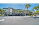 Condo building with covered parking and lush landscaping at 4380 Exeter Dr # 303, Longboat Key, FL 34228