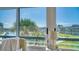 Bright view overlooking the canal, palm trees, and condo complex through a window at 4380 Exeter Dr # 303, Longboat Key, FL 34228