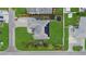 Aerial view of a single-Gathering home with solar panels, a well-maintained lawn, and a fenced yard at 5819 2Nd Avenue Nw Dr, Bradenton, FL 34209