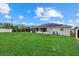 Spacious backyard with lush green grass, back patio, and well-maintained landscaping at 5819 2Nd Avenue Nw Dr, Bradenton, FL 34209
