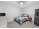 Cozy bedroom with wood-look tile floors, a ceiling fan, and a comfortable bed with modern decor and neutral-colored walls at 5819 2Nd Avenue Nw Dr, Bradenton, FL 34209