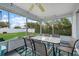 Enclosed patio featuring a large glass table and multiple chairs with views of the backyard at 5819 2Nd Avenue Nw Dr, Bradenton, FL 34209