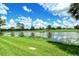 Serene lake view with lush green grass at 5241 Mahogany Run Ave # 412, Sarasota, FL 34241