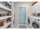 Laundry room with washer, dryer, and additional pantry shelving at 5819 2Nd Avenue Nw Dr, Bradenton, FL 34209