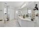 Clean bathroom with a double vanity and access to backyard at 5819 2Nd Avenue Nw Dr, Bradenton, FL 34209