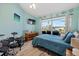 Bedroom with teal bedding, large window, and drum set at 5819 2Nd Avenue Nw Dr, Bradenton, FL 34209