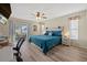 Spacious main bedroom with a teal comforter and access to a patio at 5819 2Nd Avenue Nw Dr, Bradenton, FL 34209