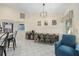 Kitchen dining area with farmhouse table and teal chairs at 5819 2Nd Avenue Nw Dr, Bradenton, FL 34209