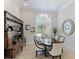 Formal dining room featuring a wood table and sideboard with an ornate mirror at 3342 Founders Club Dr, Sarasota, FL 34240