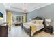 Spacious main bedroom with a king-size bed and access to the backyard at 3342 Founders Club Dr, Sarasota, FL 34240