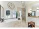 Elegant Primary bathroom with soaking tub, walk-in shower, and dual vanities at 3342 Founders Club Dr, Sarasota, FL 34240