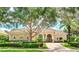 One-story home with tile roof, double doors, and manicured landscaping at 3342 Founders Club Dr, Sarasota, FL 34240