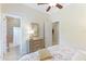 Bedroom with floral bedding, dresser, en-suite bathroom, and window at 3342 Founders Club Dr, Sarasota, FL 34240