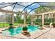 Inviting pool and patio area with covered lanai, lush landscaping, and comfortable seating at 3342 Founders Club Dr, Sarasota, FL 34240