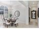 Elegant dining room with a large table, chandelier, and arched window at 3342 Founders Club Dr, Sarasota, FL 34240