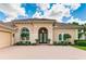 One-story home with tile roof and double doors, lush landscaping at 3342 Founders Club Dr, Sarasota, FL 34240