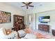 Spacious home office with built-in desk, TV, and comfortable seating at 3342 Founders Club Dr, Sarasota, FL 34240