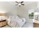 Charming bedroom with floral bedding, nightstands, and plenty of natural light at 3342 Founders Club Dr, Sarasota, FL 34240