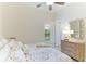 Bright bedroom with floral bedding, dresser, and large window at 3342 Founders Club Dr, Sarasota, FL 34240