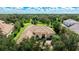 Luxury home with tile roof and driveway, surrounded by lush trees at 3342 Founders Club Dr, Sarasota, FL 34240