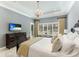 Main bedroom with king bed, dresser, and access to private patio at 3342 Founders Club Dr, Sarasota, FL 34240