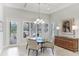 Bright dining room with a glass-top table and custom wood buffet at 3342 Founders Club Dr, Sarasota, FL 34240