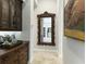 Hallway with a large ornate mirror and artwork at 3342 Founders Club Dr, Sarasota, FL 34240