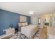 Serene bedroom featuring blue walls, a king-size bed, and access to bathroom at 1365 Sussex Rd, Venice, FL 34293