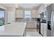 Modern kitchen with stainless steel appliances and an island at 8705 Ocean Tides Cv, Parrish, FL 34219