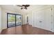 Bedroom featuring a large closet, hardwood floors, and sliding glass doors to the screened pool area at 14636 Newtonmore Ln, Lakewood Ranch, FL 34202