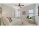 Bedroom featuring neutral tones, ample natural light, and a comfortable chair and decor at 14636 Newtonmore Ln, Lakewood Ranch, FL 34202