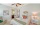 Comfortable bedroom with white walls, ceiling fan, and a view into the connecting bathroom at 14636 Newtonmore Ln, Lakewood Ranch, FL 34202