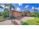 Lovely home with a three-car garage, paver driveway and tile roof, enhanced by palm trees and lush landscaping at 14636 Newtonmore Ln, Lakewood Ranch, FL 34202