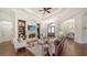 Beautiful living room with fireplace and built-in shelving seamlessly flowing into the dining area and featuring an elegant entryway at 14636 Newtonmore Ln, Lakewood Ranch, FL 34202