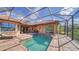 Gorgeous screened-in pool and spa area with outdoor kitchen, seating and beautiful landscaping at 14636 Newtonmore Ln, Lakewood Ranch, FL 34202