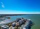 Expansive aerial view reveals waterfront condos surrounded by a vibrant harbor and cityscape skyline at 226 Golden Gate Pt # 64, Sarasota, FL 34236