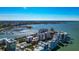 Overhead shot displays waterfront condos next to a harbor with a cityscape, blending residential with urban charm at 226 Golden Gate Pt # 64, Sarasota, FL 34236