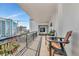 Condo balcony with seating and a view of the city skyline at 226 Golden Gate Pt # 64, Sarasota, FL 34236