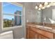 Bathroom with granite countertops, natural wood cabinets and a large window at 226 Golden Gate Pt # 64, Sarasota, FL 34236
