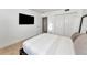 Bedroom featuring a minimalist design, closet, and wall-mounted television at 226 Golden Gate Pt # 64, Sarasota, FL 34236