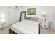 Bright bedroom with a queen bed, modern decor, and ample closet space at 226 Golden Gate Pt # 64, Sarasota, FL 34236
