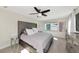 Bright bedroom featuring a tufted headboard, neutral walls, tile flooring, and a ceiling fan at 226 Golden Gate Pt # 64, Sarasota, FL 34236