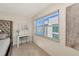 Bright bedroom with tiled floors, a vanity with Hollywood lighting and a large window at 226 Golden Gate Pt # 64, Sarasota, FL 34236