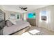 Bright bedroom with tiled floors, a large dresser and large windows with sheer curtains at 226 Golden Gate Pt # 64, Sarasota, FL 34236