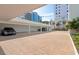 Spacious carport with brick pavement offering covered parking and protection from the elements for multiple vehicles at 226 Golden Gate Pt # 64, Sarasota, FL 34236