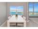 Elegant dining area showcasing water views, stylish furniture, and abundant natural light at 226 Golden Gate Pt # 64, Sarasota, FL 34236