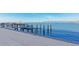 Waterfront community dock with benches, boat lift and views of bridge at 226 Golden Gate Pt # 64, Sarasota, FL 34236